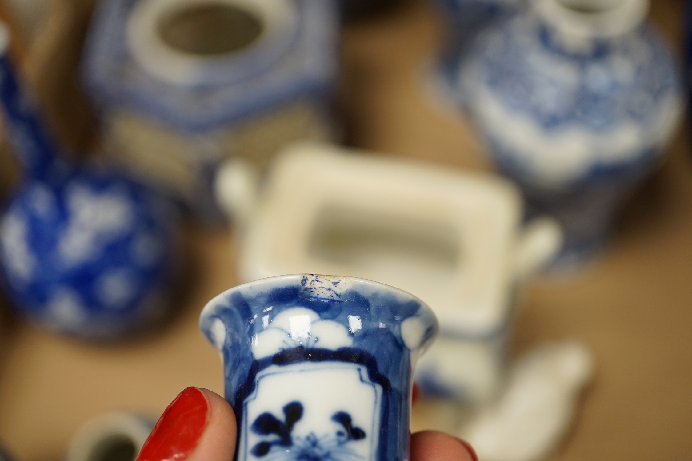 A collection of 18th - early 20th century Chinese blue and white porcelain vases, jars and spare covers, together with some Japanese blue and white ceramics, tallest 21cm